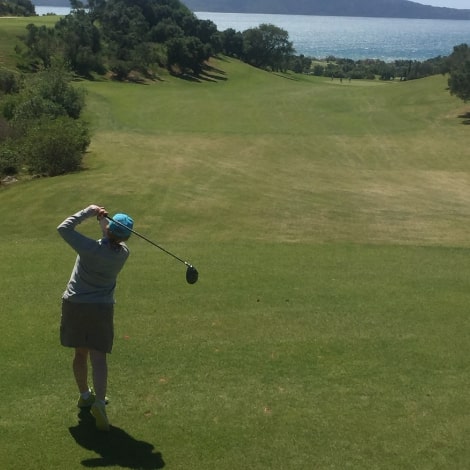 playing golf with sea view